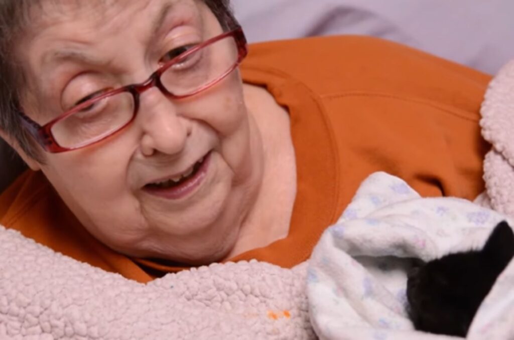 sick woman holding a kitten