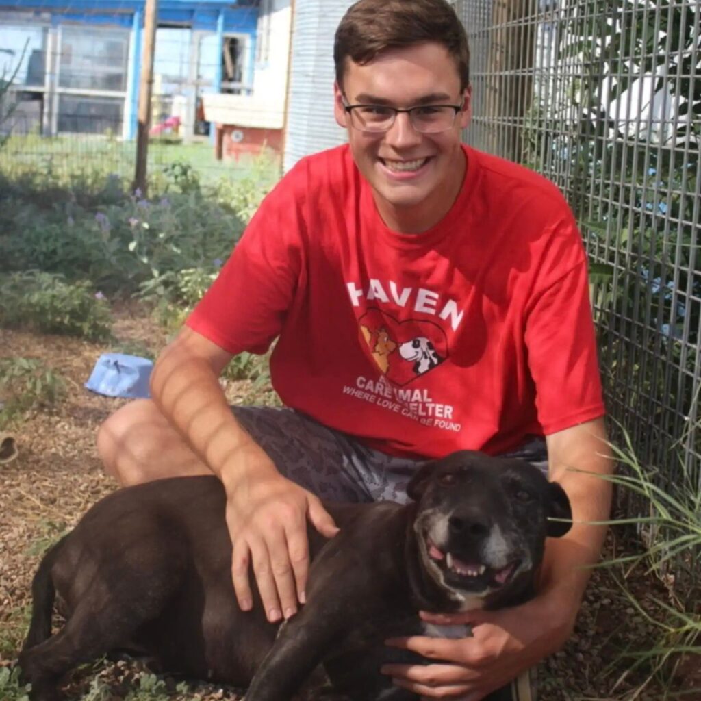 smiling boy with a black dog