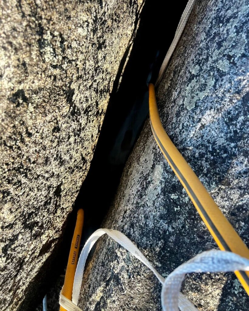 two hoses lowered between rocks