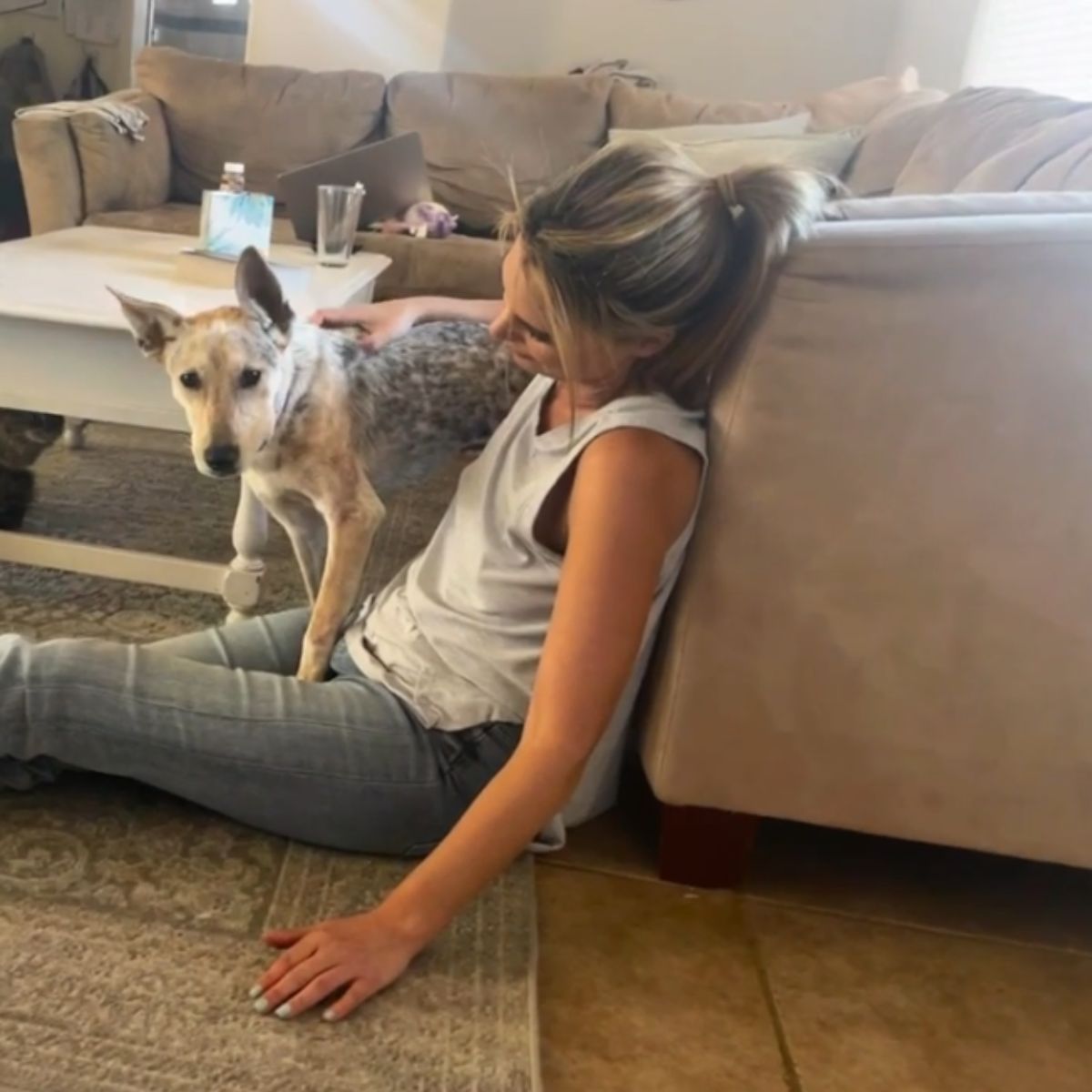 woman cuddles a coyote