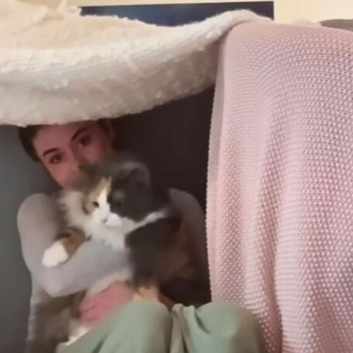 woman hugging senior cat