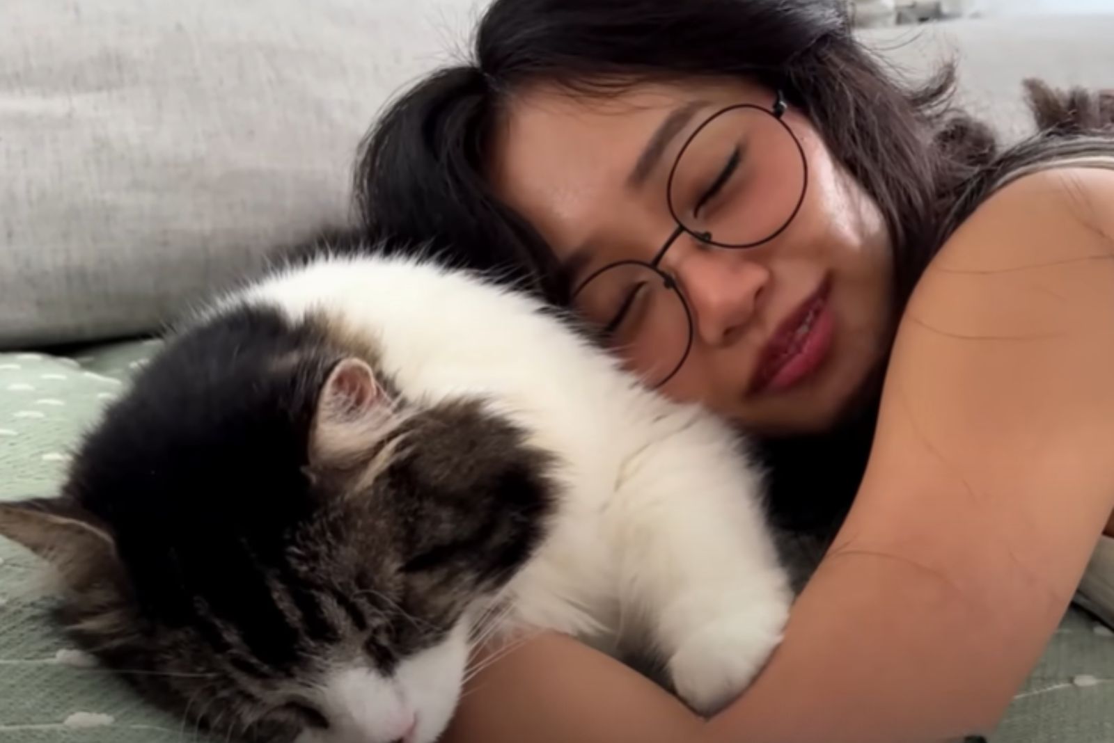 woman sleeps with a shelter cat