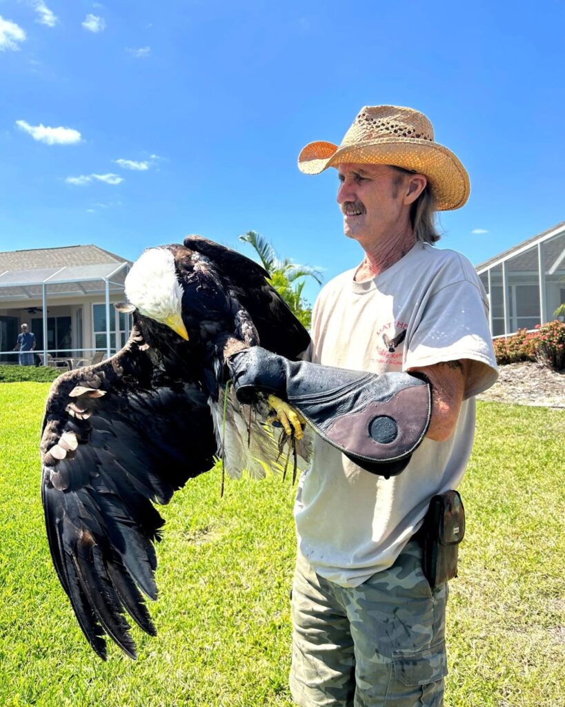 A man holds an eagle in his hand