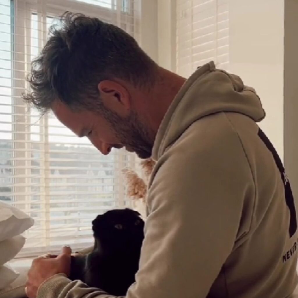 The dog is looking at the man