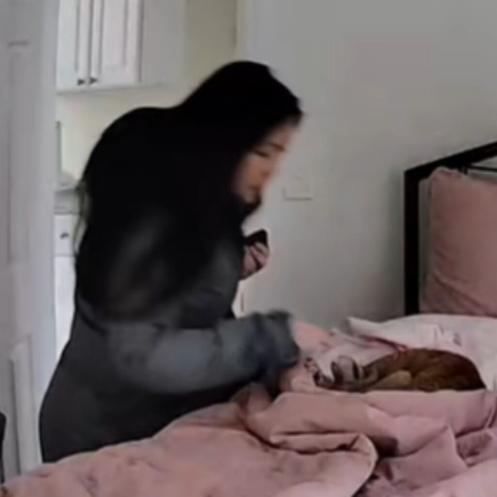 The woman approaches the bed