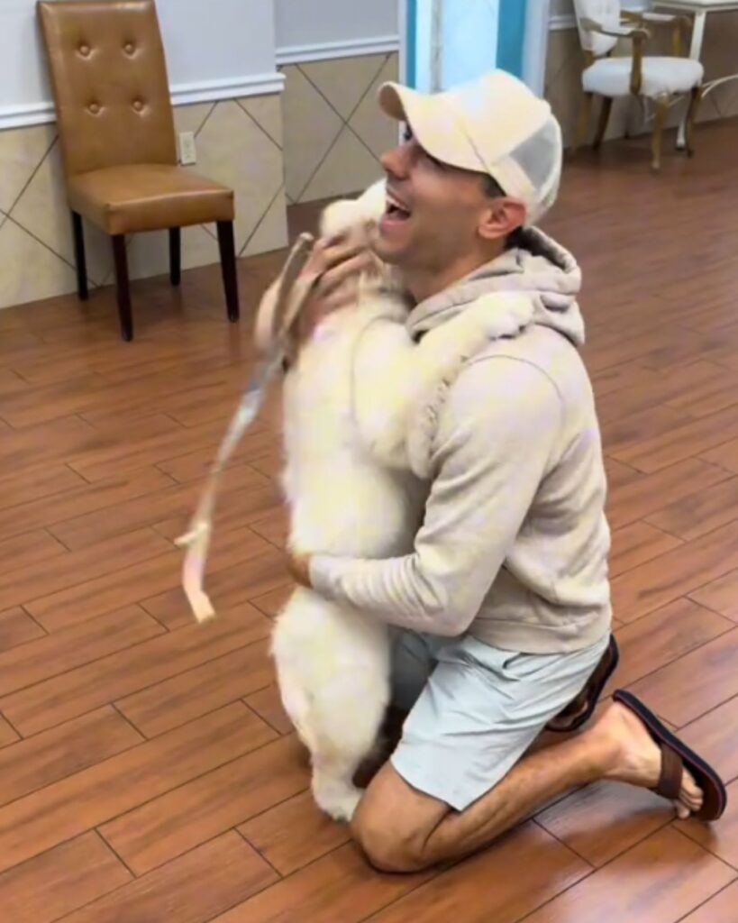 a man hugs a dog