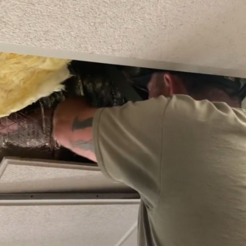 a man is pulling something out of the wall