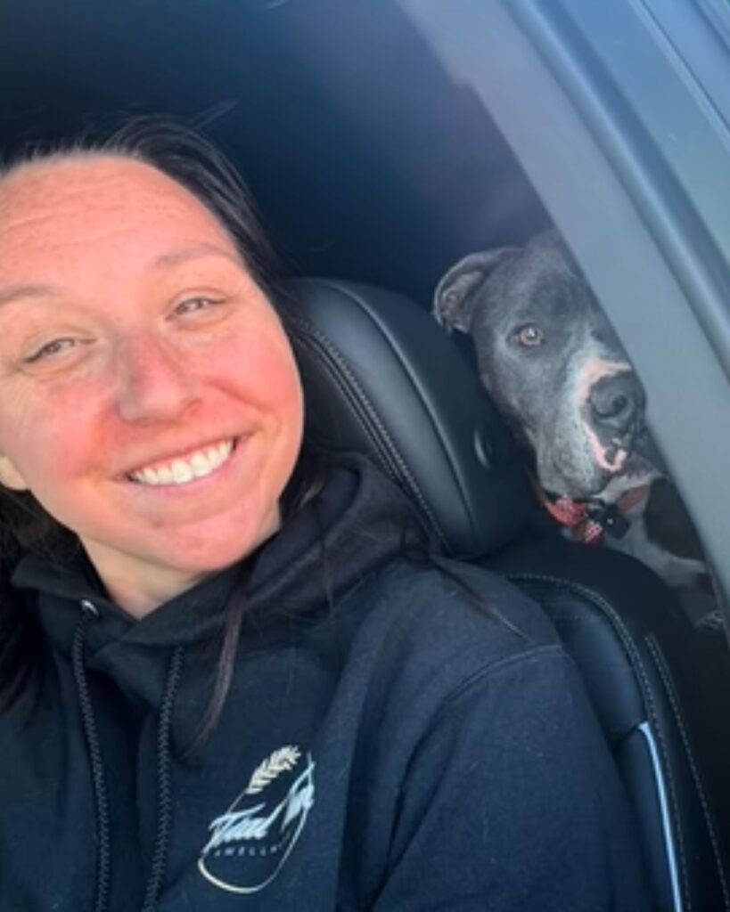 a woman takes a picture with a dog