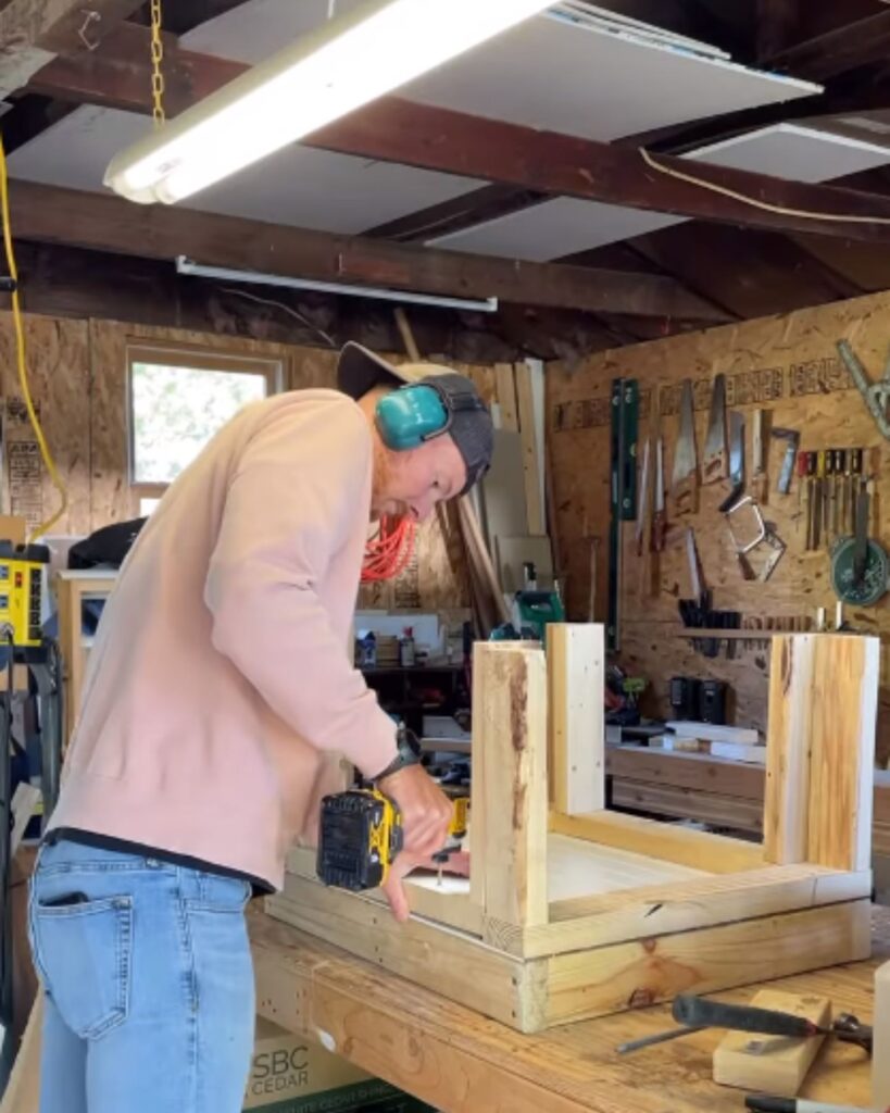 man screwing a table