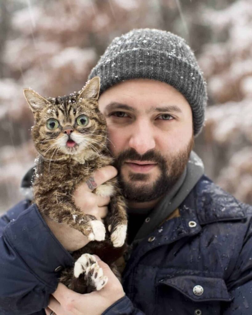 man with a big-eyed cat