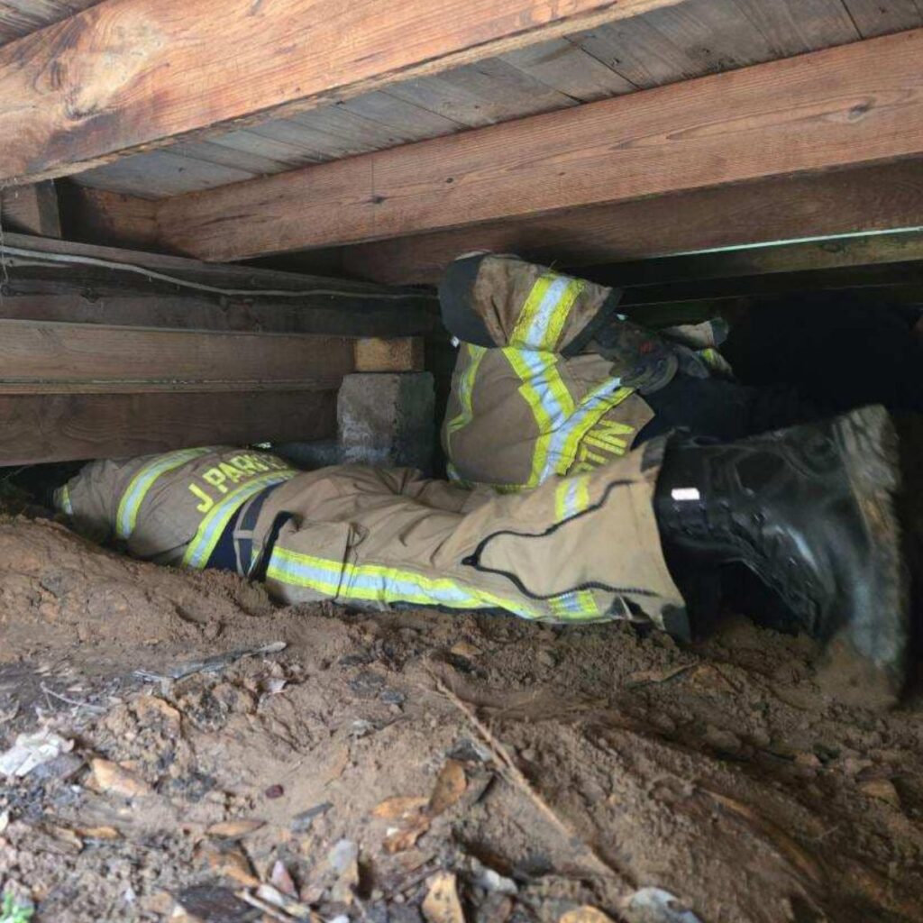 firefighters in crawlspace