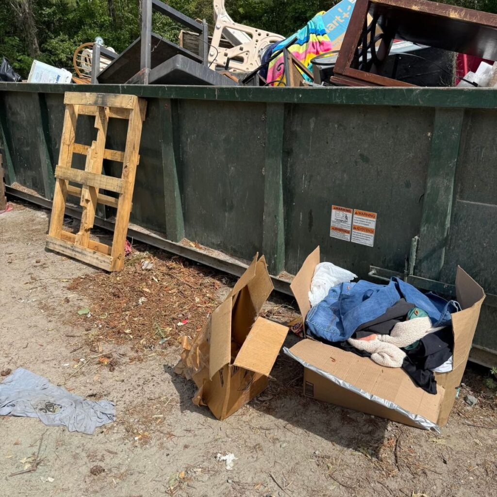 large dumpster with boxes in front of it