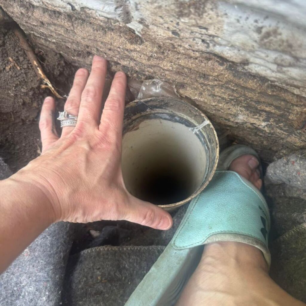 woman's hand on a storm drain tube