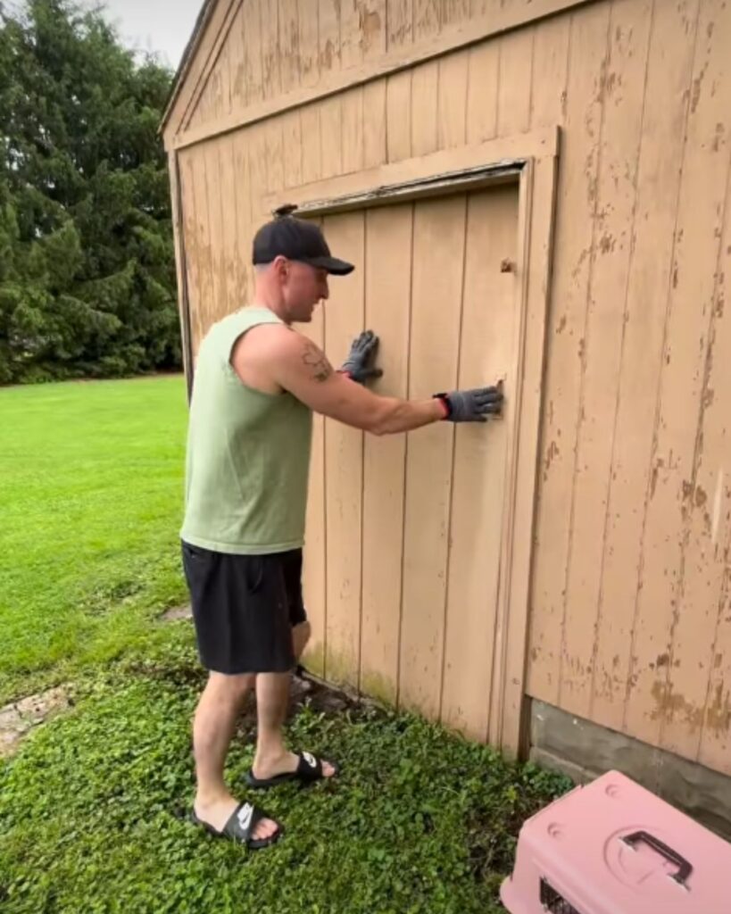 man opening a shed