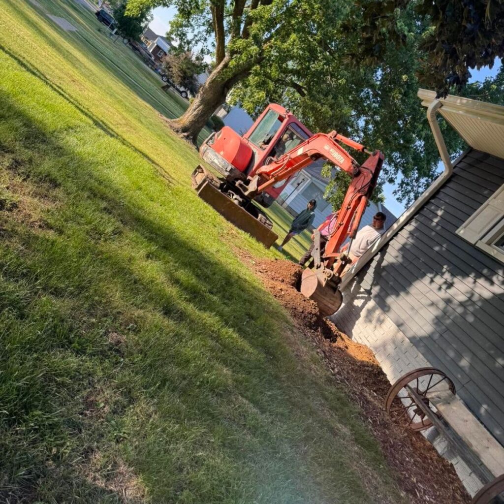 excavator digging near a house