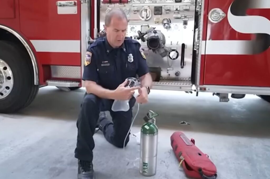 firefighter holding an oxygen mask