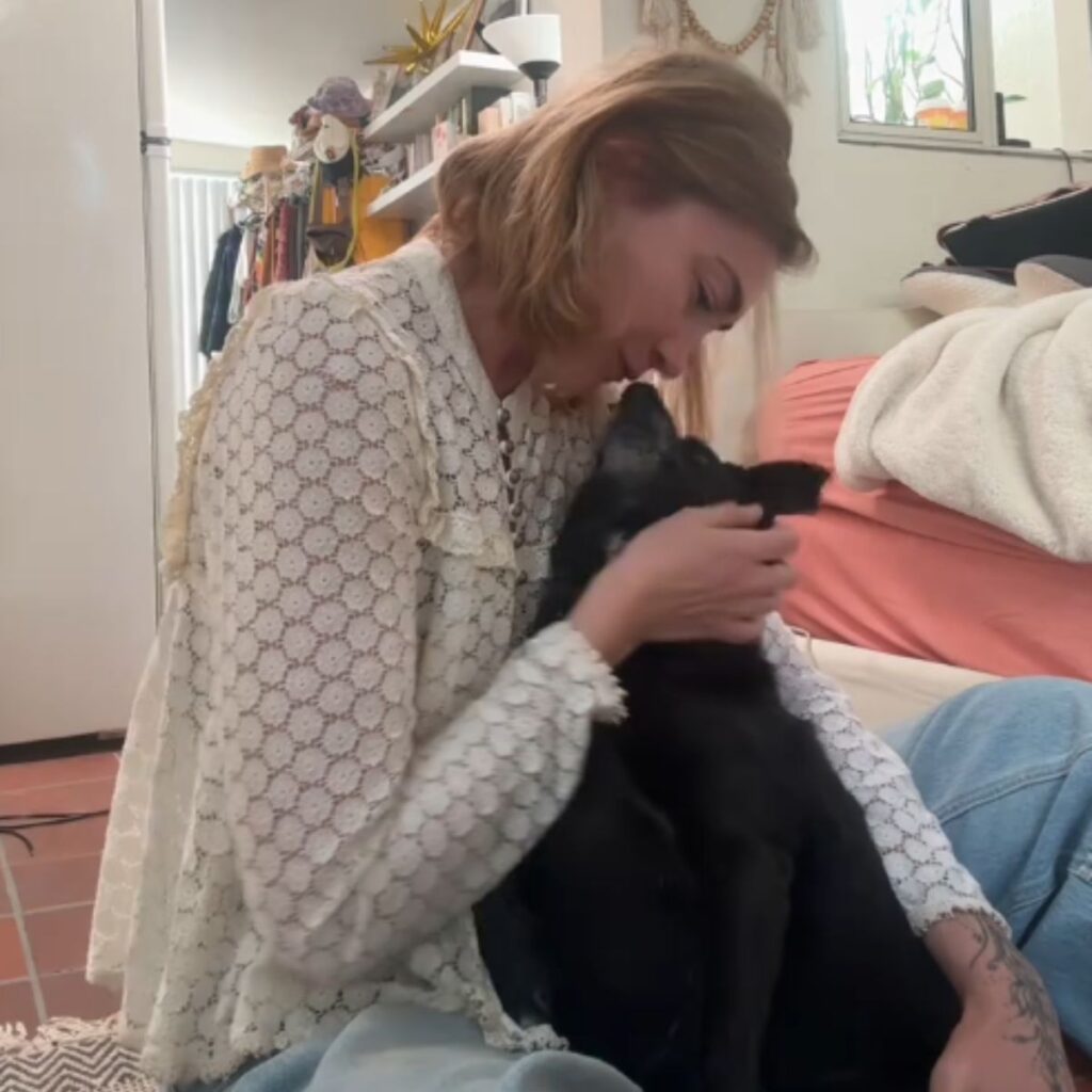 woman and dog cuddling