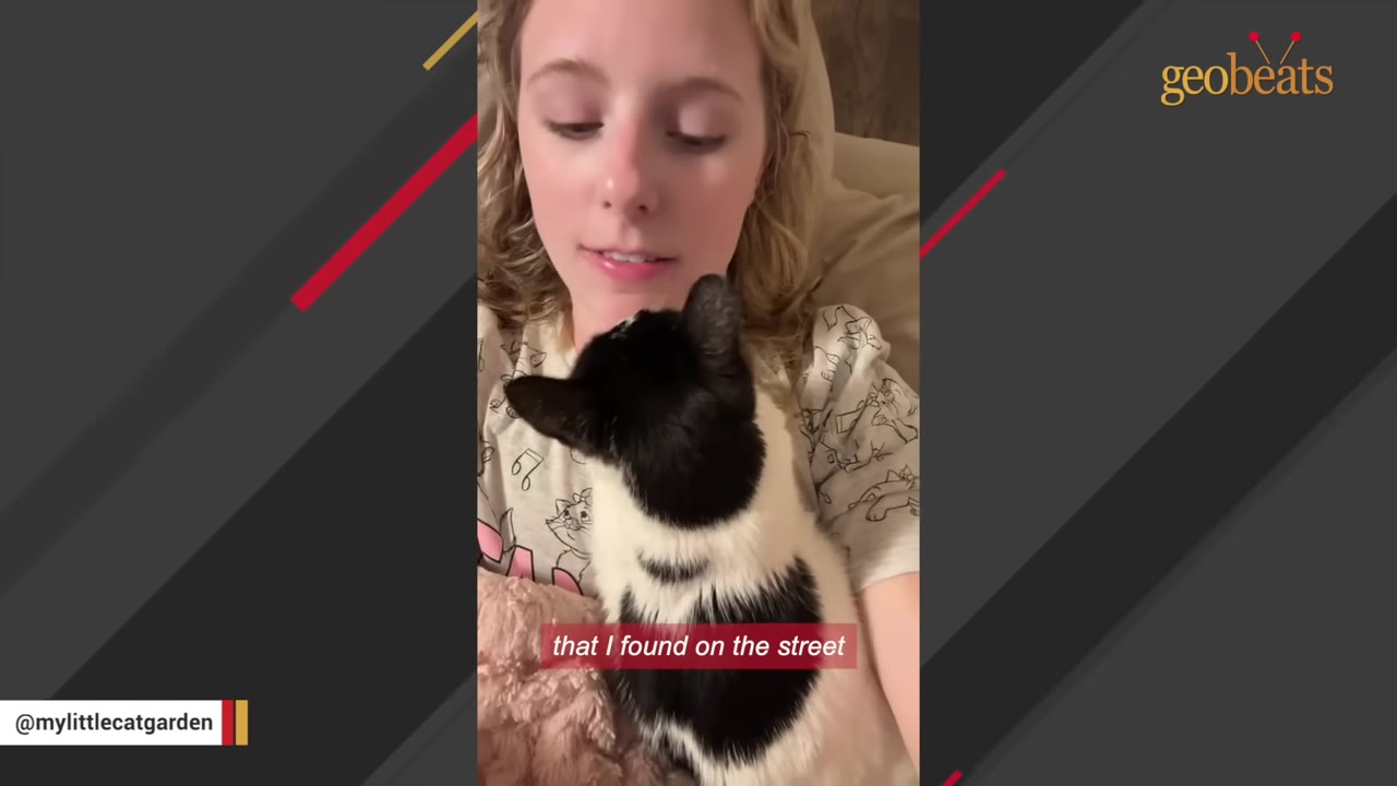 A young woman with blonde hair looks down lovingly at a black and white cat snuggled against her chest.