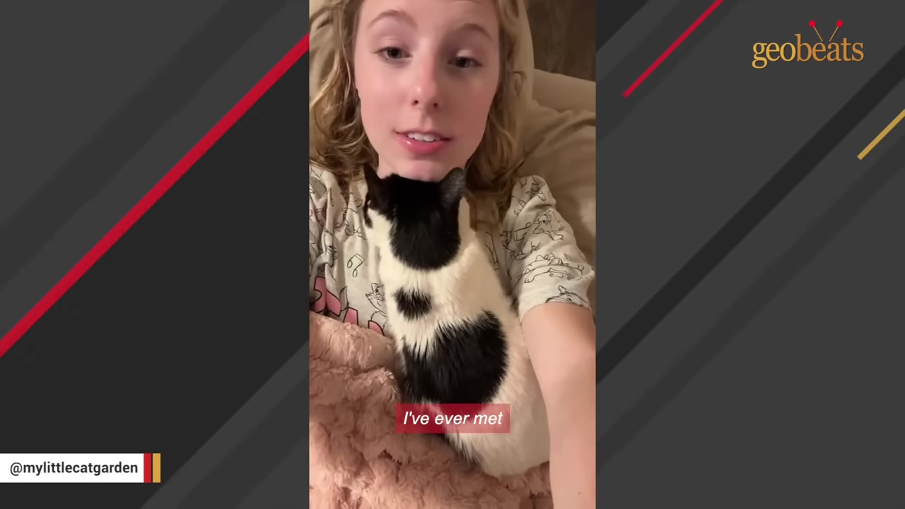 A young woman with blonde hair lies down indoors with a black and white cat resting gently on her chest.