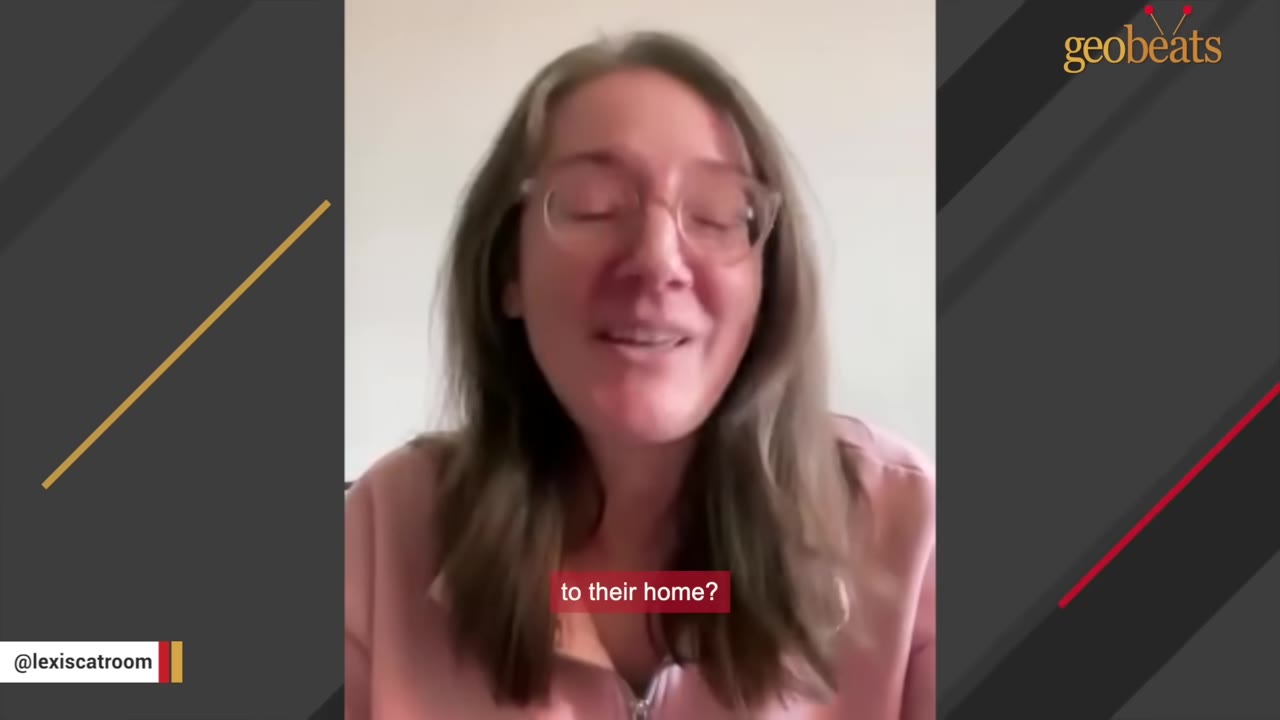 A woman with glasses and brown hair speaking directly to the camera.