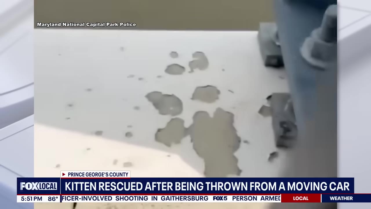 A close-up shot of a white metal bridge structure with peeling paint, shown in a news broadcast from Maryland National Capital Park Police.