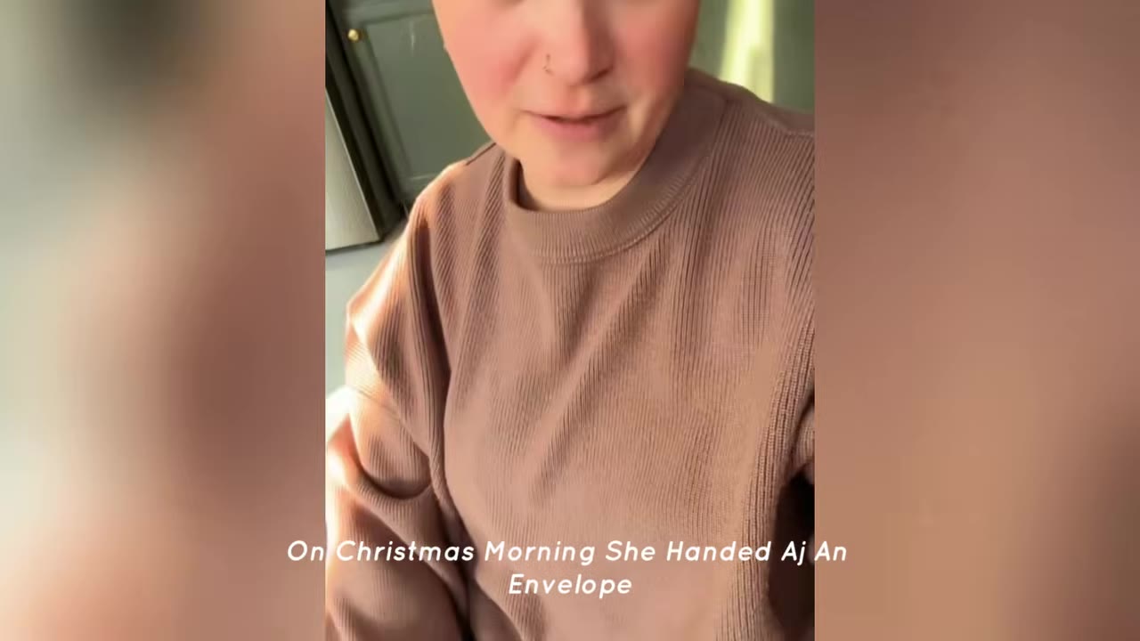 A close-up of a person wearing a brown knit sweater, with text overlay reading 'On Christmas Morning She Handed Aj An Envelope'.