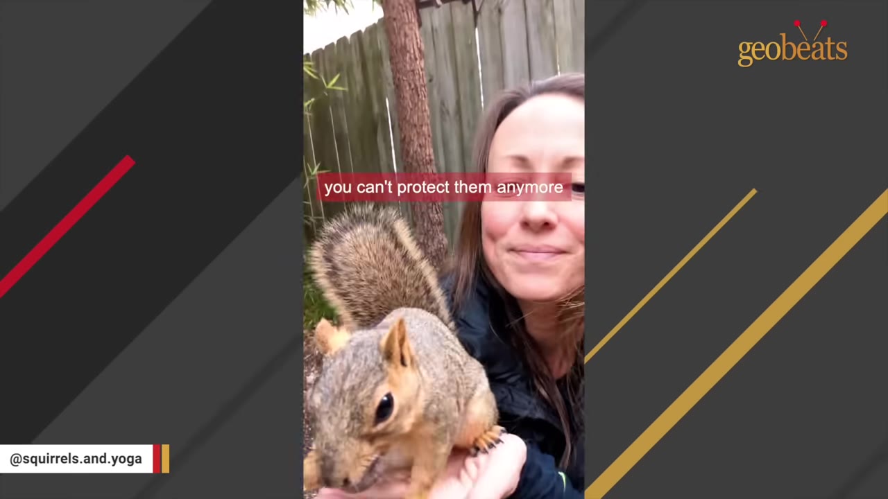 A close-up of a squirrel sitting calmly in a woman's hands as she smiles warmly at it.
