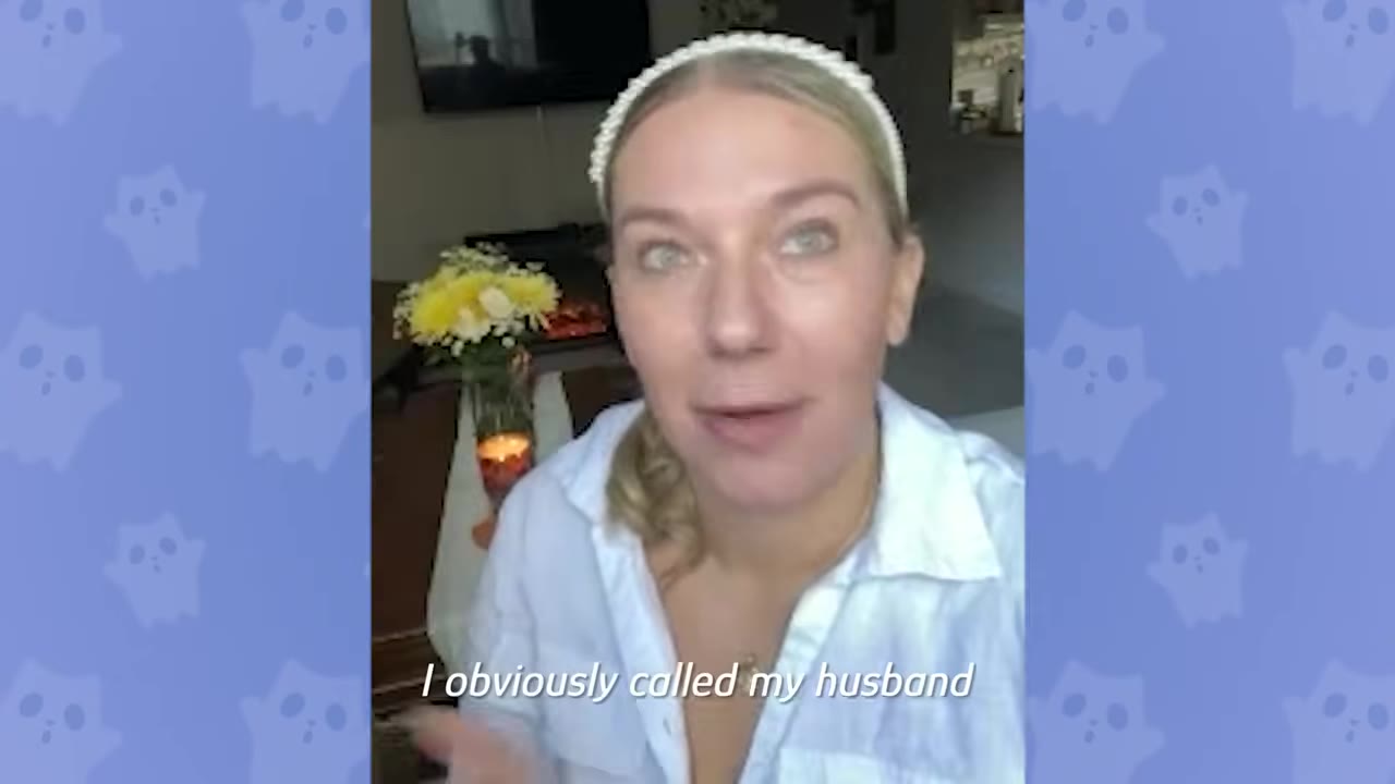 A woman with a white headband and white shirt looks directly at the camera with a surprised expression, with the caption 'I obviously called my husband' on screen.