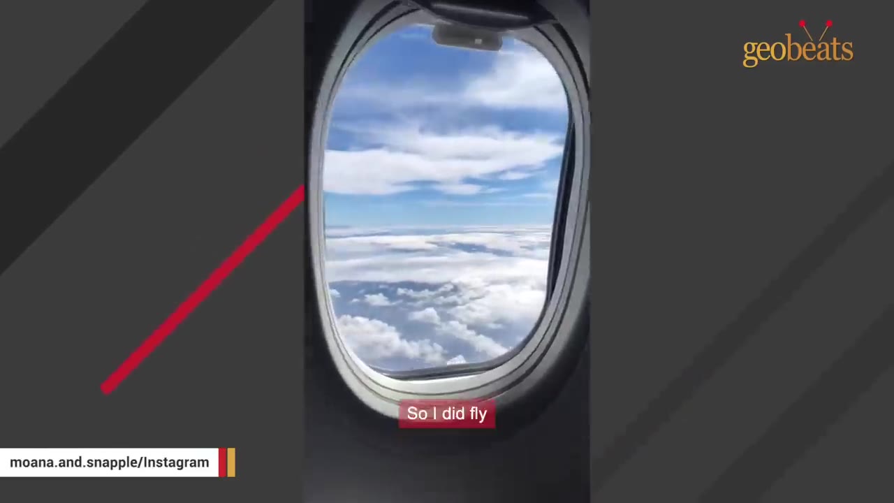 A view of clouds and blue sky through an airplane window during a flight.