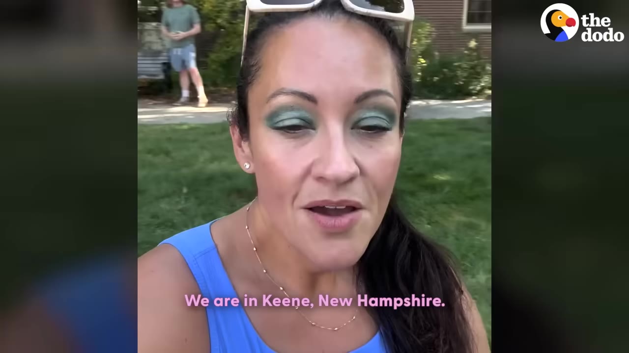 A woman with sunglasses on her head and green eyeshadow speaks to the camera, with a caption that reads, 'We are in Keene, New Hampshire.'