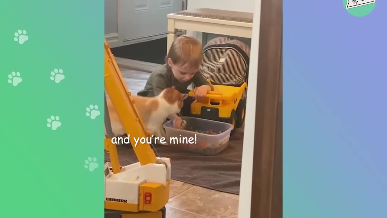 A young boy sits on the floor next to an orange and white cat, with a yellow toy truck nearby and text overlay reading 'and you're mine!'.