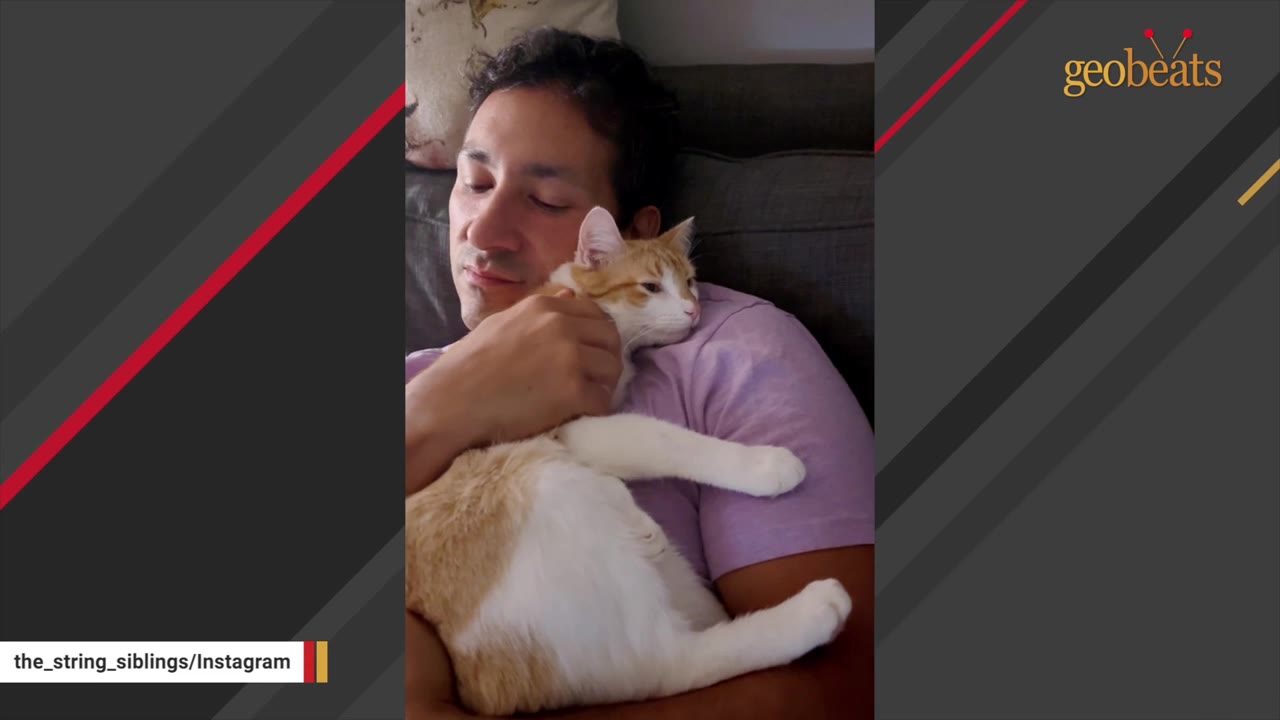 A man with dark hair cuddles an orange and white cat resting on his chest.